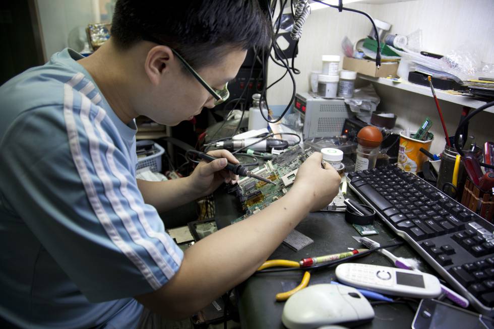 Un hombre repara unos circuitos en Beijing, China.